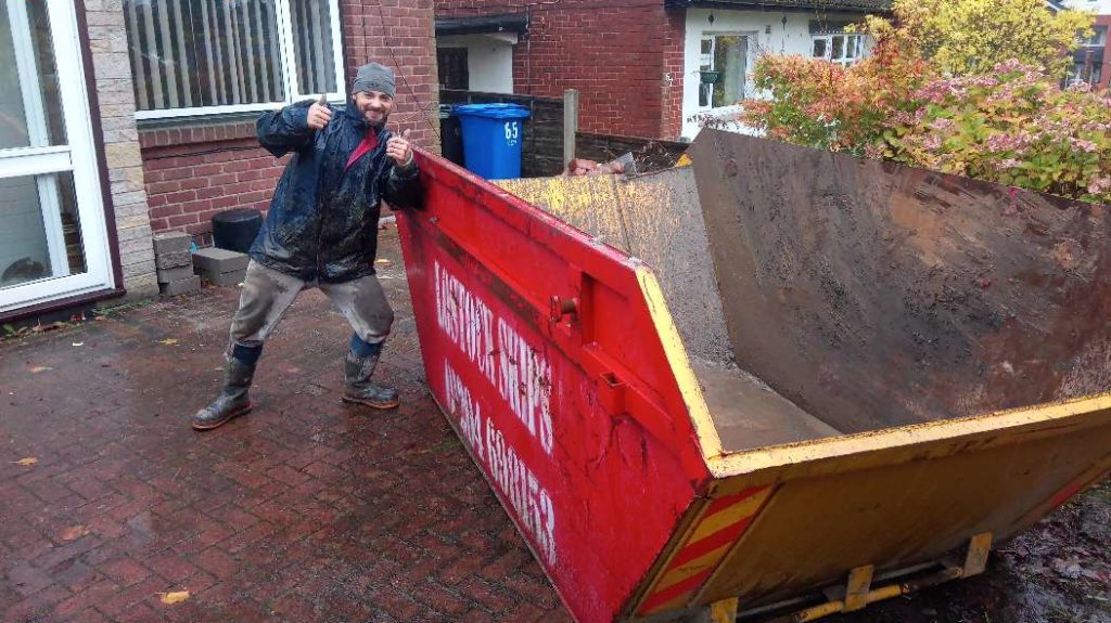 Happy Customer with Skip Outside of his house